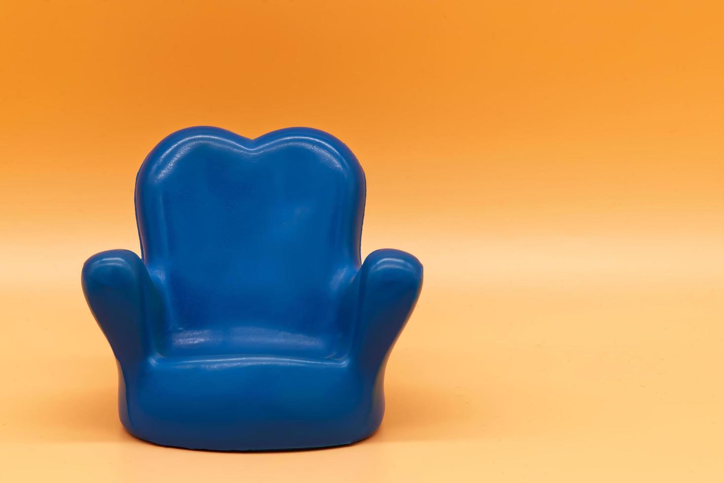 Rubber blue armchair isolated on orange background photo