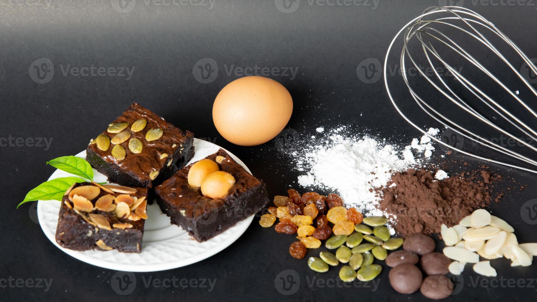 Delicious chocolate brownie homemade, ingredients of brownie,closeup fudge brownie,homemade bakery and dessert,Pieces of fresh brownie,confectionery concept. photo