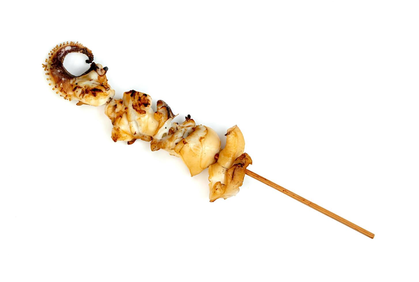 roast tentacles of squid with skewer isolated on white background photo