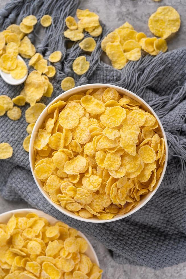 Corn flakes bowl sweets on gray cement background, top view flat lay layout design, fresh and healthy breakbast concept. photo