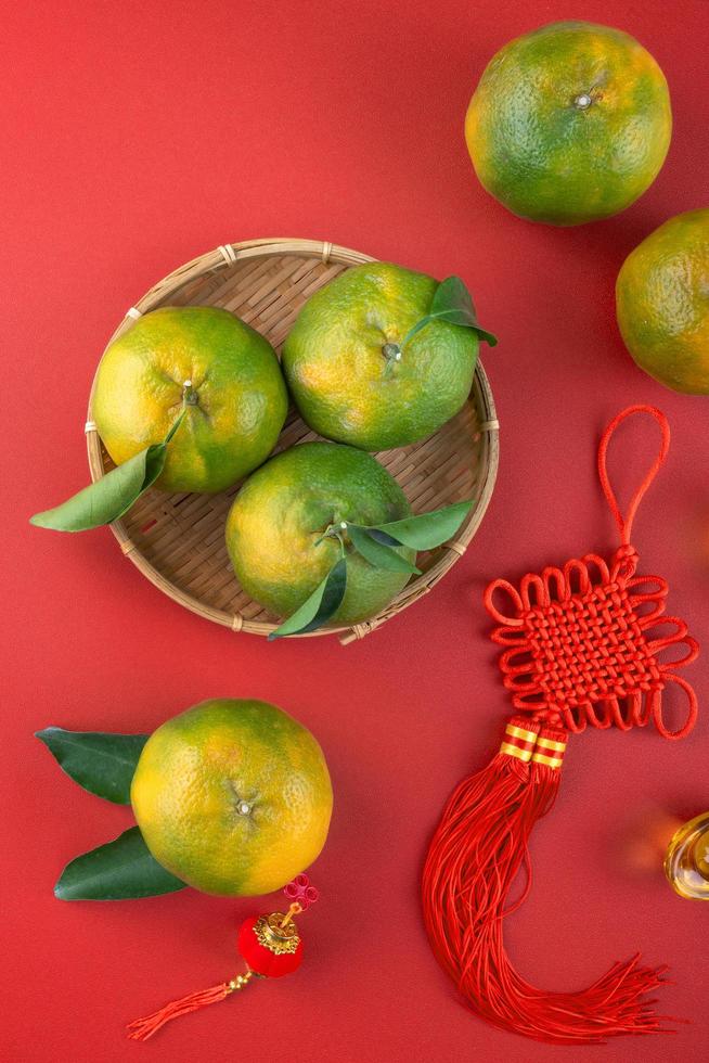 Top view of fresh tangerine mandarin orange on red background for Chinese lunar new year. photo