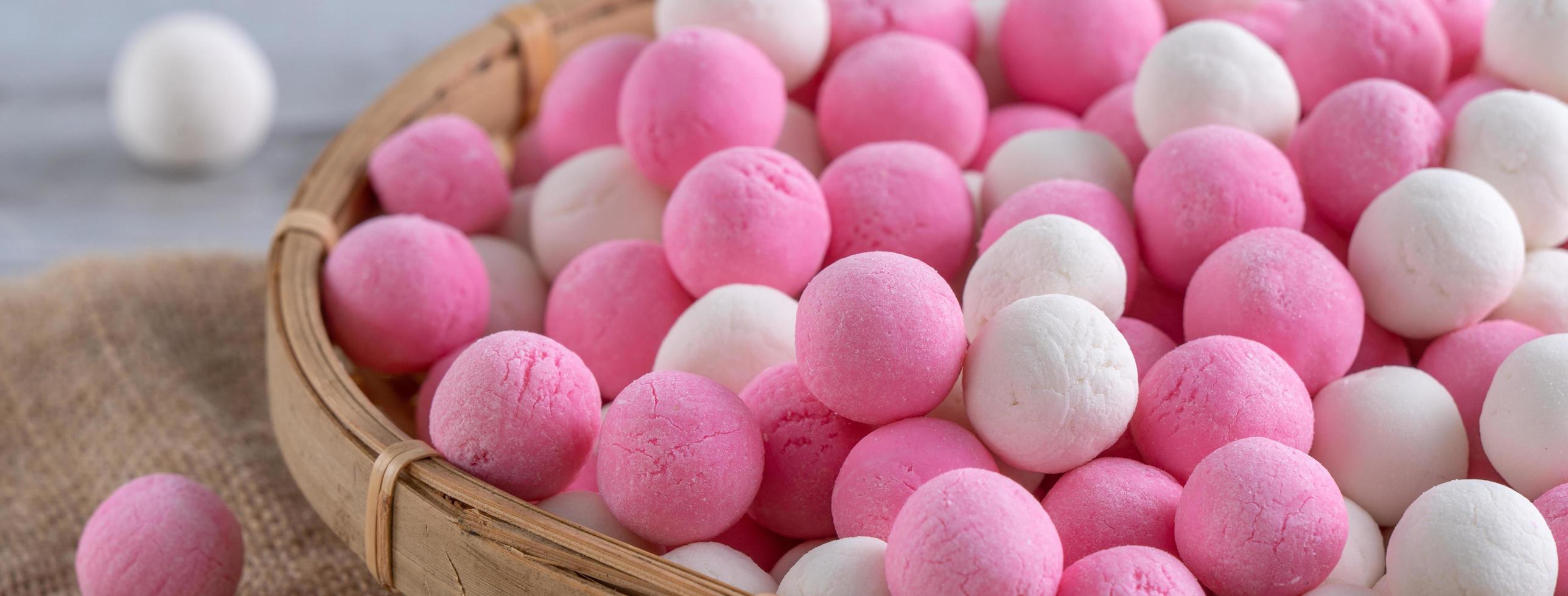 Raw red and white tangyuan on wooden table background for Winter solstice food. photo