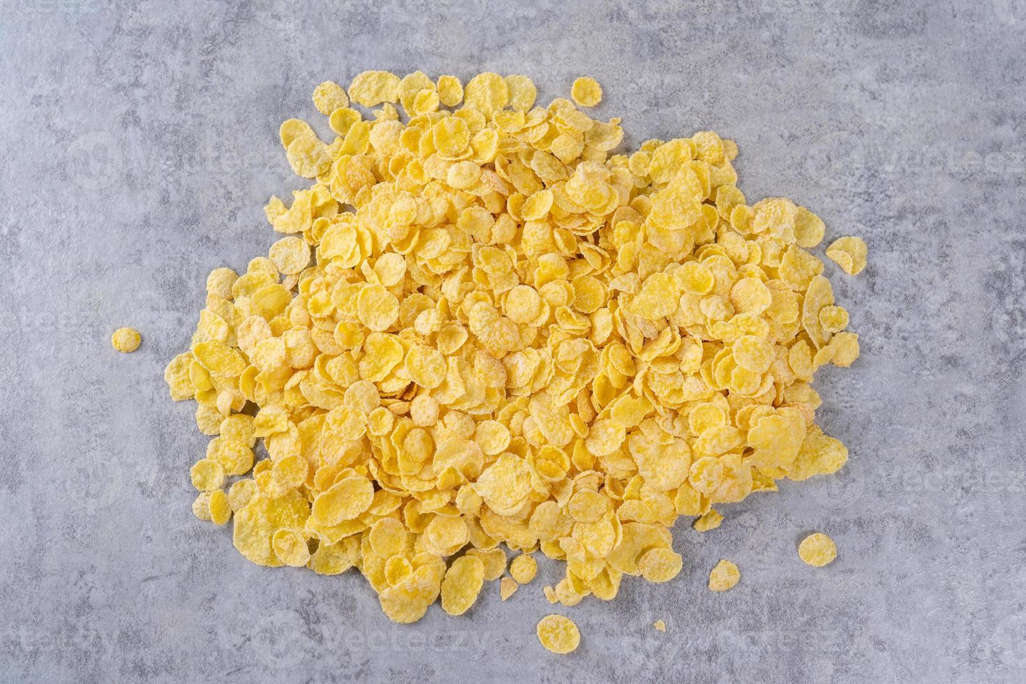 Corn flakes bowl sweets on gray cement background, top view flat lay layout design, fresh and healthy breakbast concept. photo