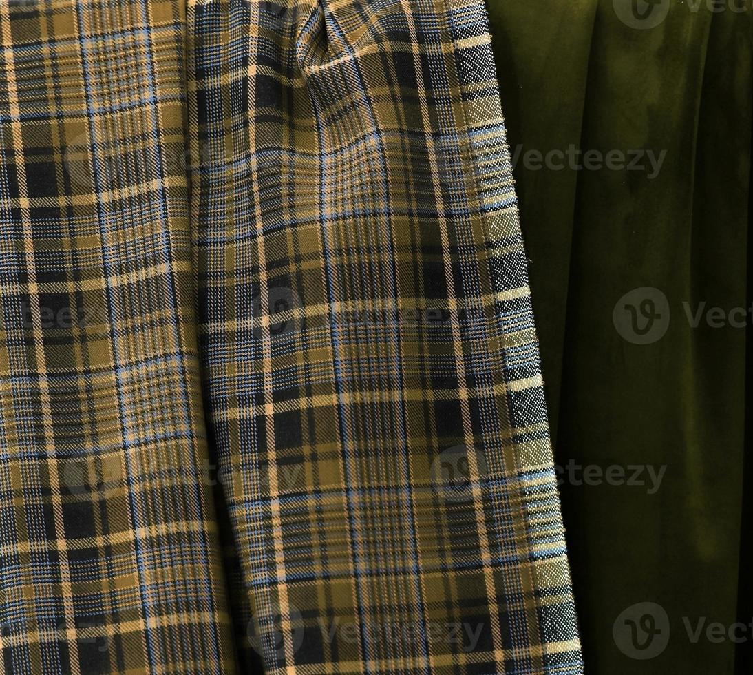 Detailed close up view on samples of cloth and fabrics in different colors found at a fabrics market photo