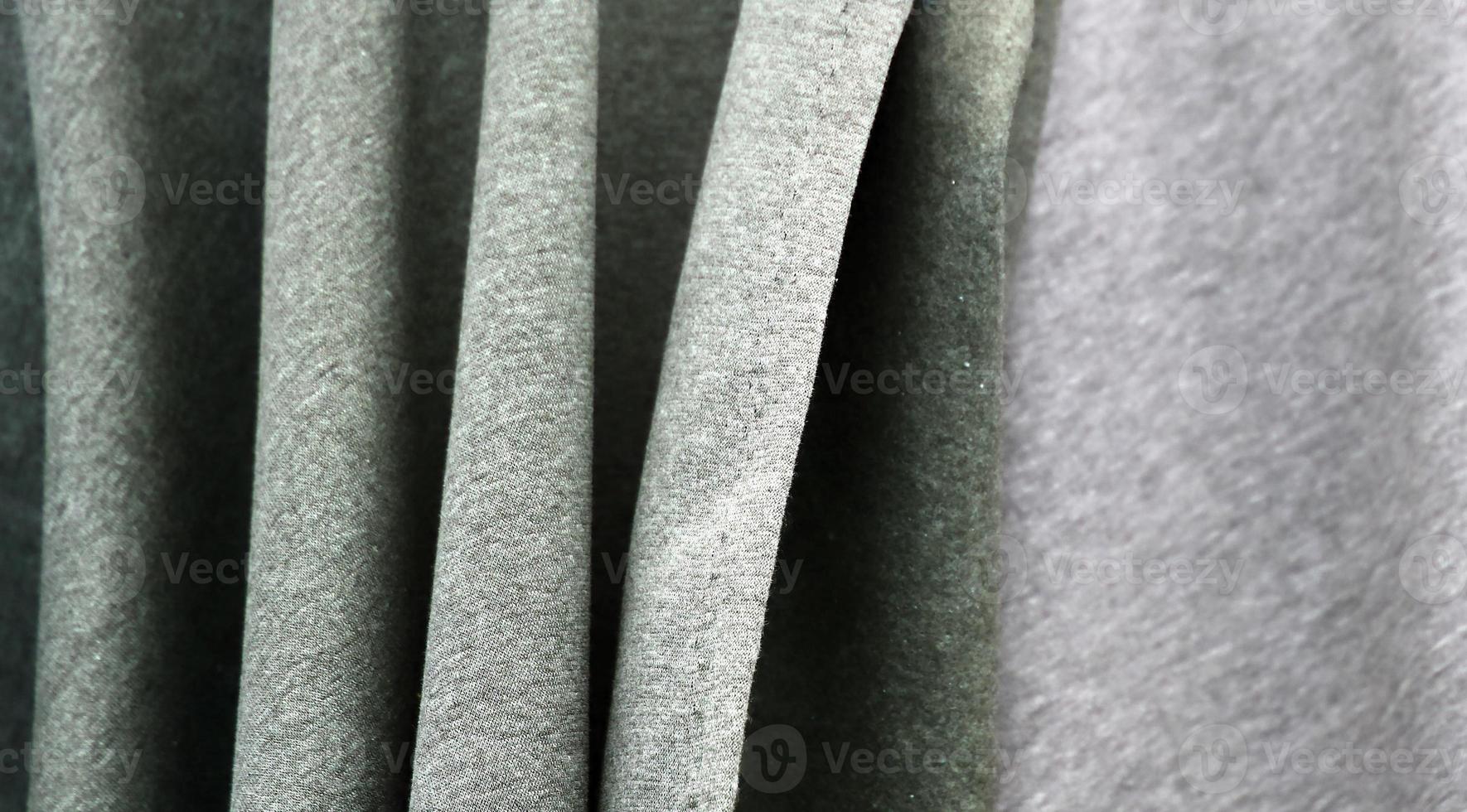 Detailed close up view on samples of cloth and fabrics in different colors found at a fabrics market photo