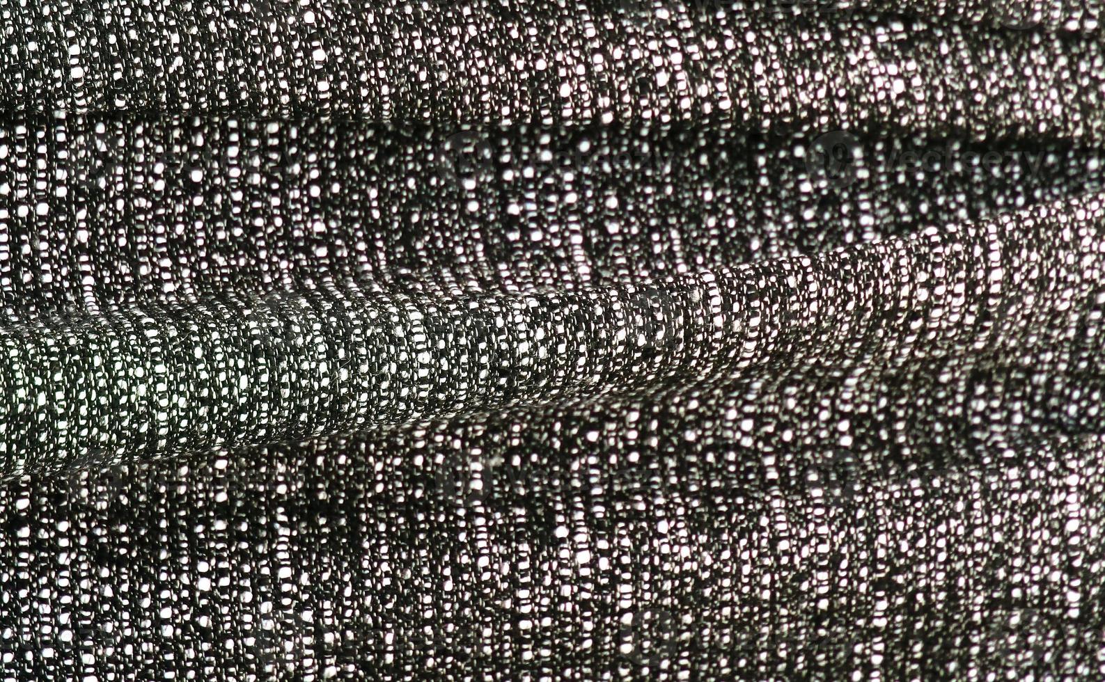 Detailed close up view on samples of cloth and fabrics in different colors found at a fabrics market photo