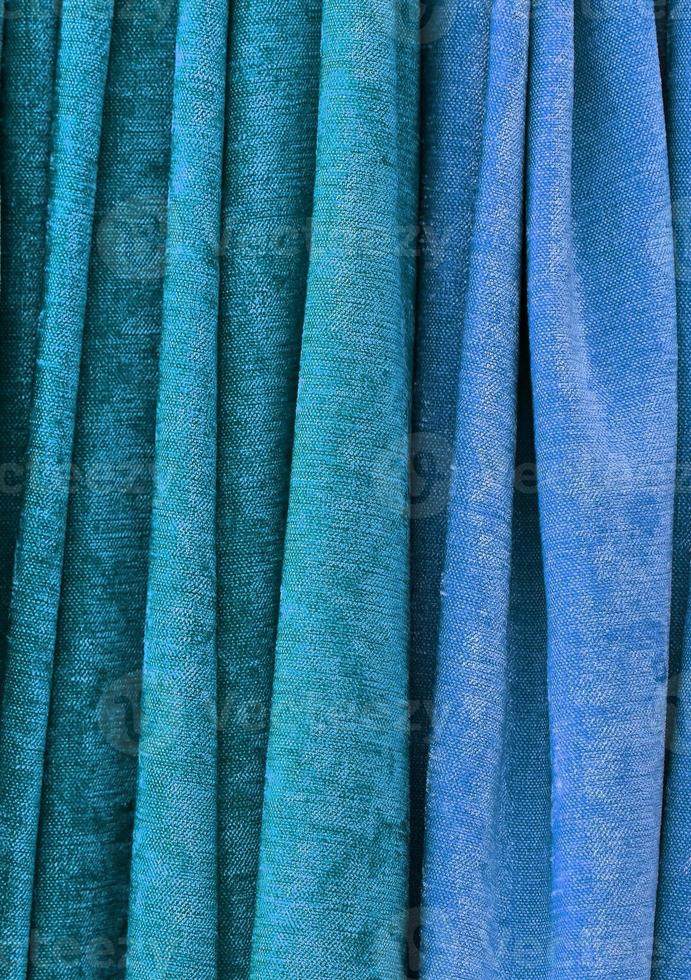 Detailed close up view on samples of cloth and fabrics in different colors found at a fabrics market photo