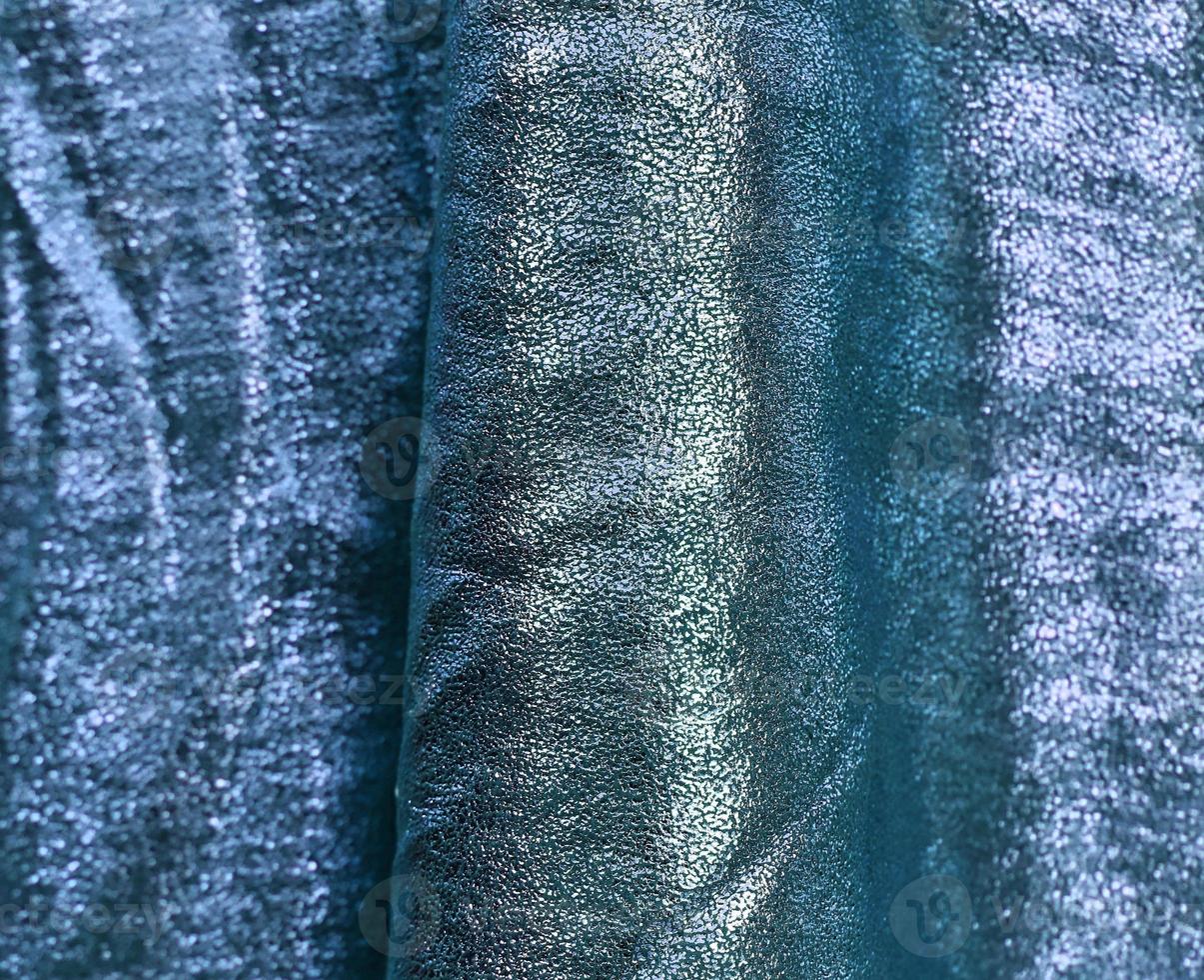 Detailed close up view on samples of cloth and fabrics in different colors found at a fabrics market photo