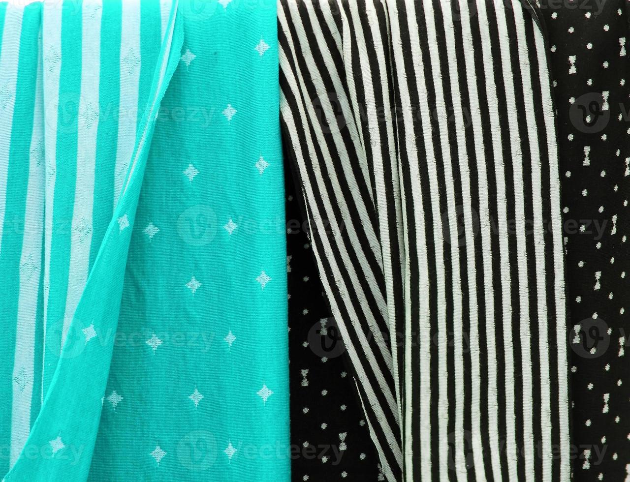 Detailed close up view on samples of cloth and fabrics in different colors found at a fabrics market photo