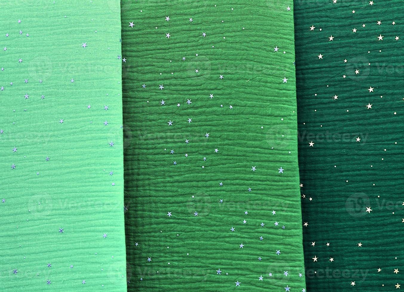 Detailed close up view on samples of cloth and fabrics in different colors found at a fabrics market photo