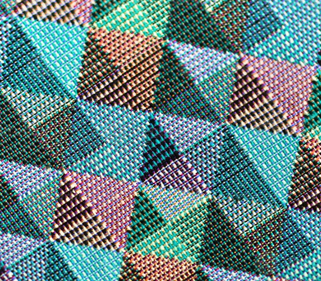 Detailed close up view on samples of cloth and fabrics in different colors found at a fabrics market photo
