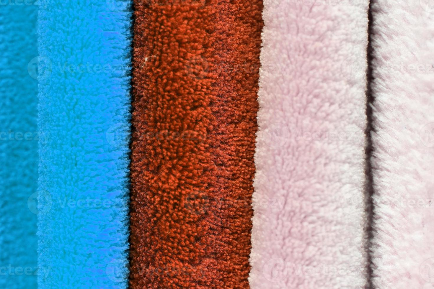 Detailed close up view on samples of cloth and fabrics in different colors found at a fabrics market photo