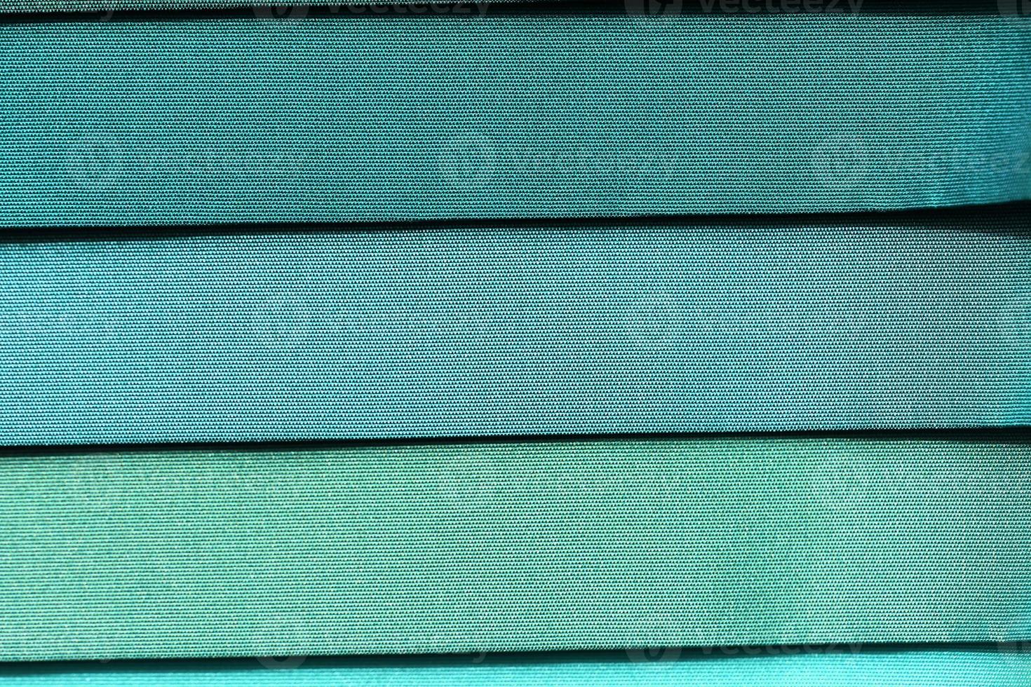 Detailed close up view on samples of cloth and fabrics in different colors found at a fabrics market photo