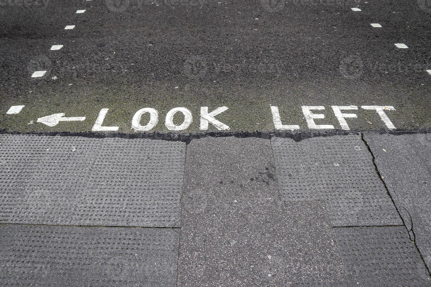 Different signs and marking painted on the ashpalt of streets and roads. photo