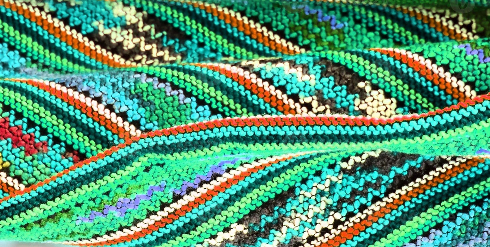 Detailed close up view on samples of cloth and fabrics in different colors found at a fabrics market photo