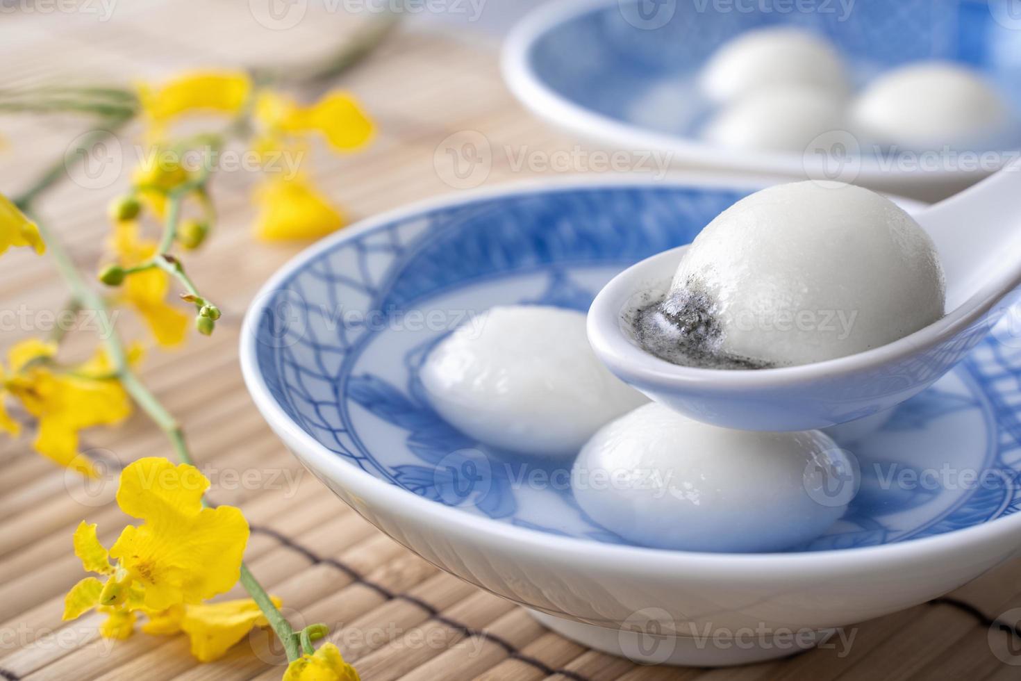 Close up of tangyuan in a bowl on gray table, food for Winter Solstice. photo