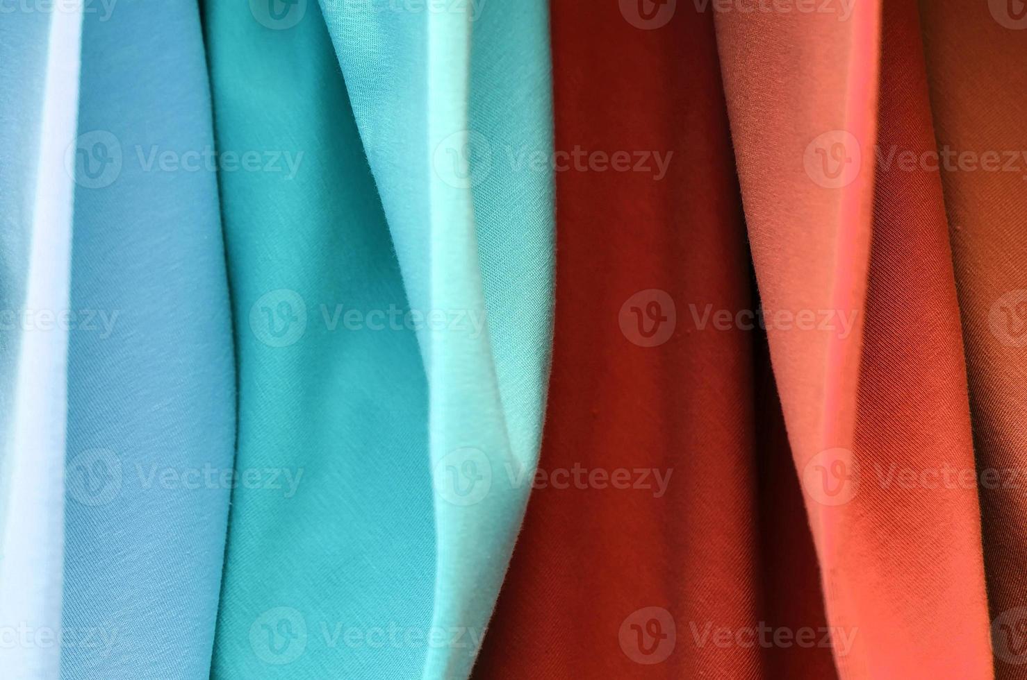 Detailed close up view on samples of cloth and fabrics in different colors found at a fabrics market photo