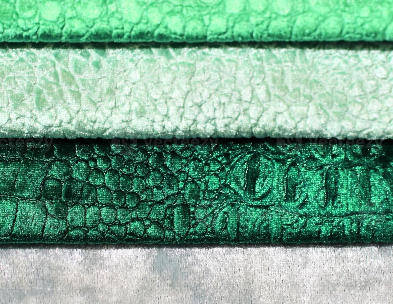 Detailed close up view on samples of cloth and fabrics in different colors found at a fabrics market photo