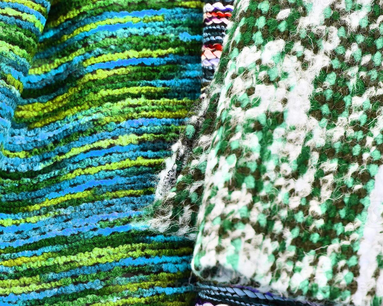 Detailed close up view on samples of cloth and fabrics in different colors found at a fabrics market photo
