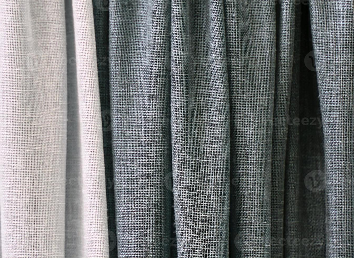 Detailed close up view on samples of cloth and fabrics in different colors found at a fabrics market photo