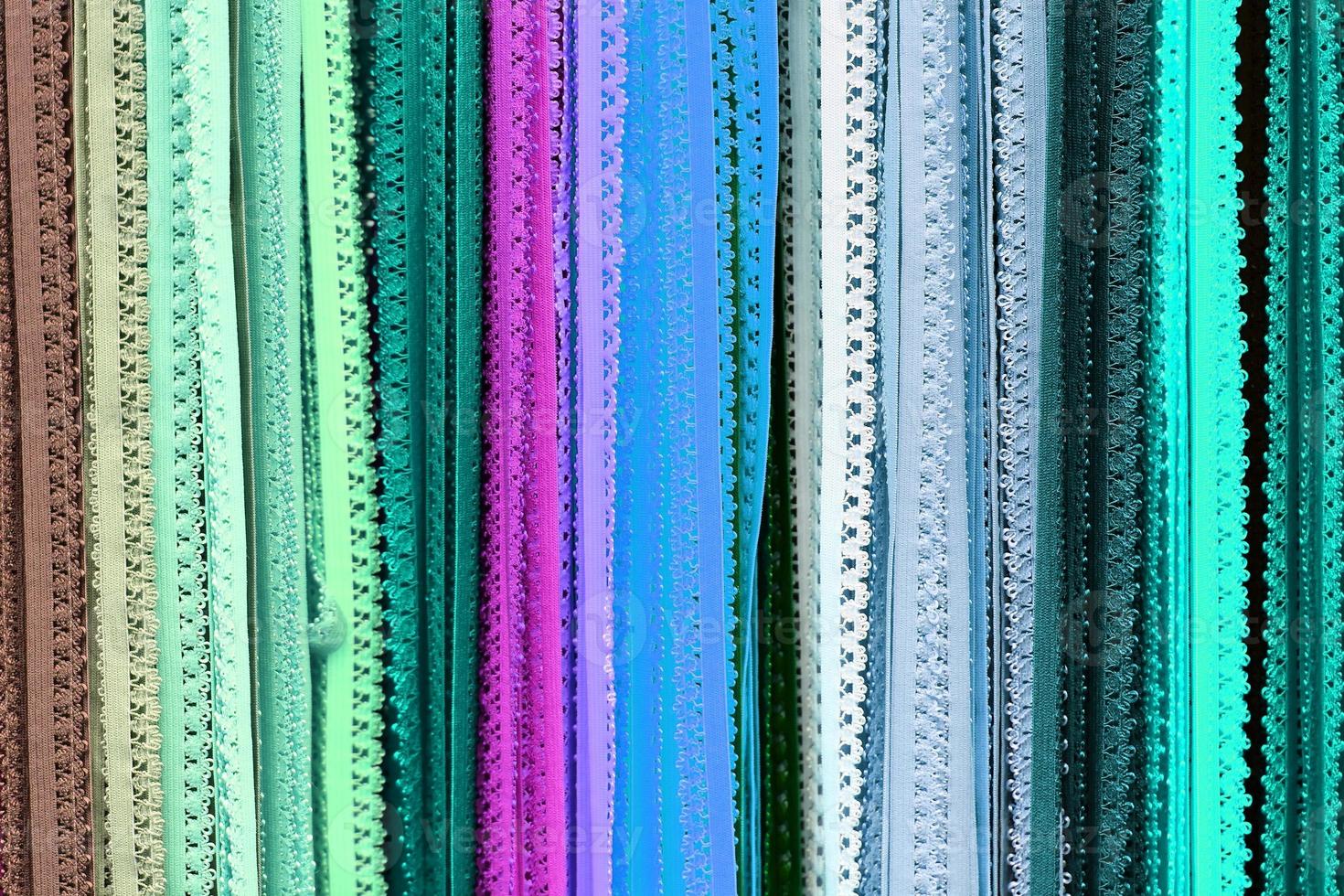 Detailed close up view on samples of cloth and fabrics in different colors found at a fabrics market photo