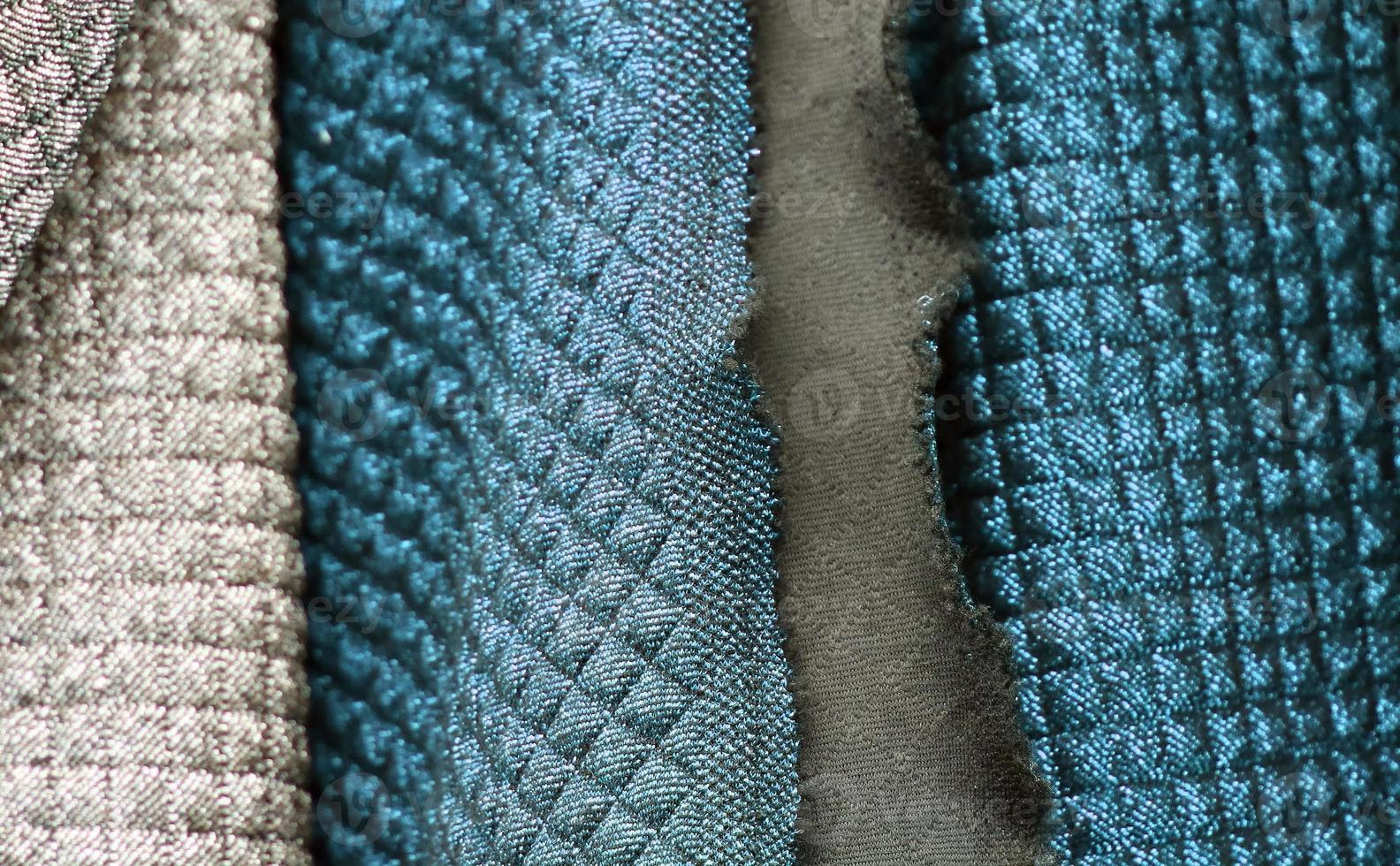 Detailed close up view on samples of cloth and fabrics in different colors found at a fabrics market photo