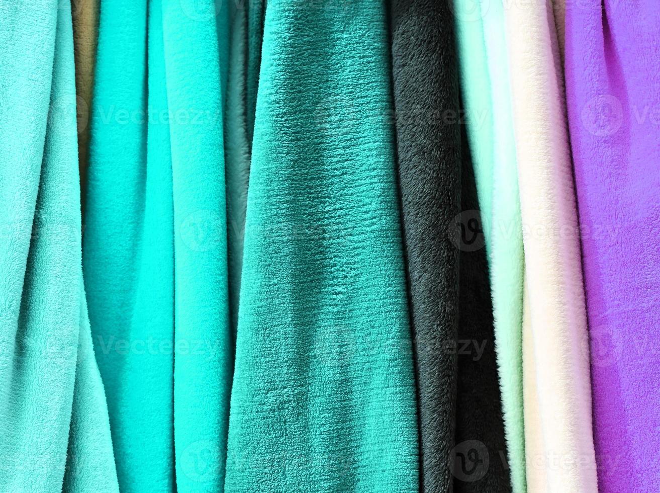 Detailed close up view on samples of cloth and fabrics in different colors found at a fabrics market photo