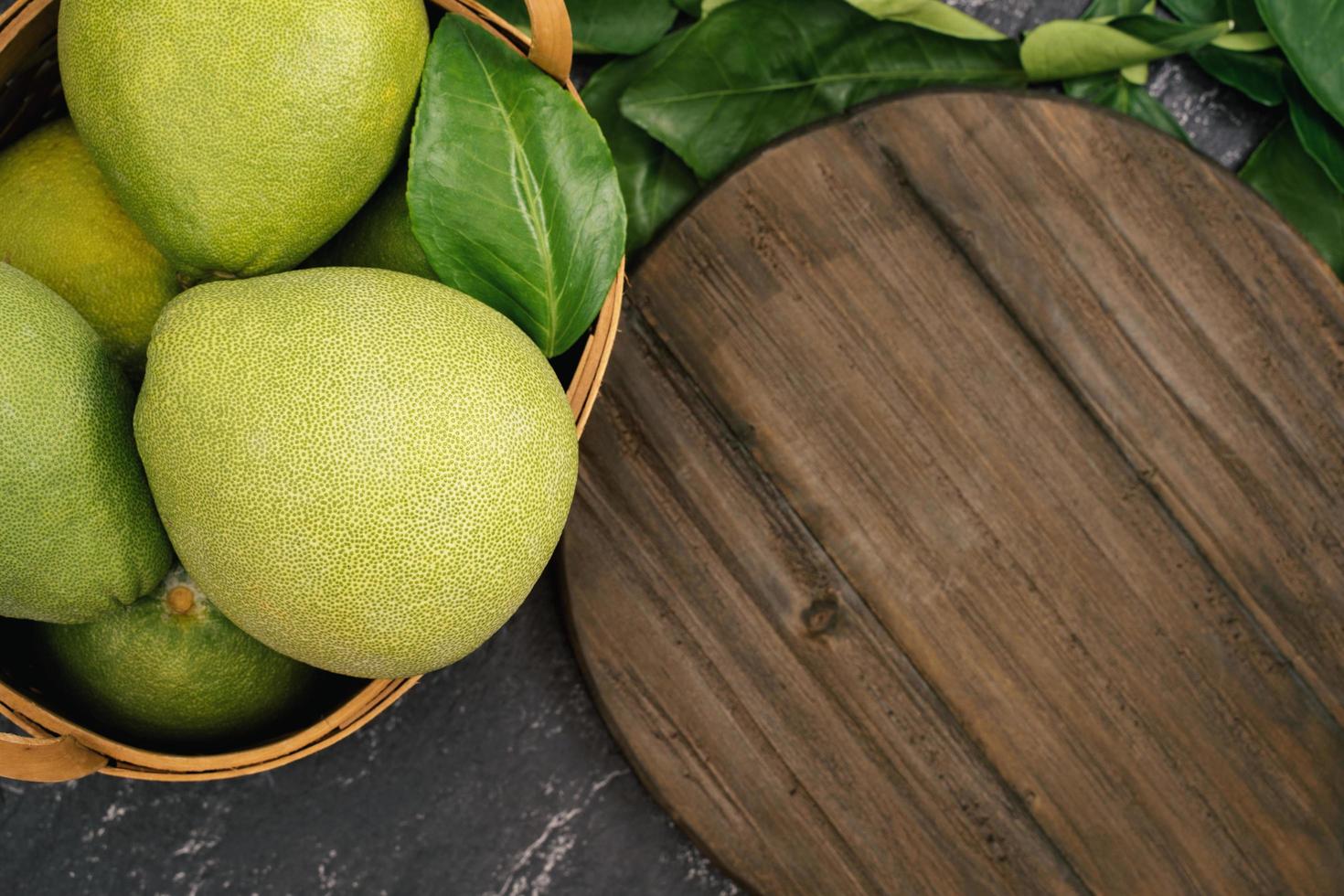 Fresh pomelo, pummelo, grapefruit, shaddock on black background, fruit for Mid-autumn festival, top view, flat lay. photo