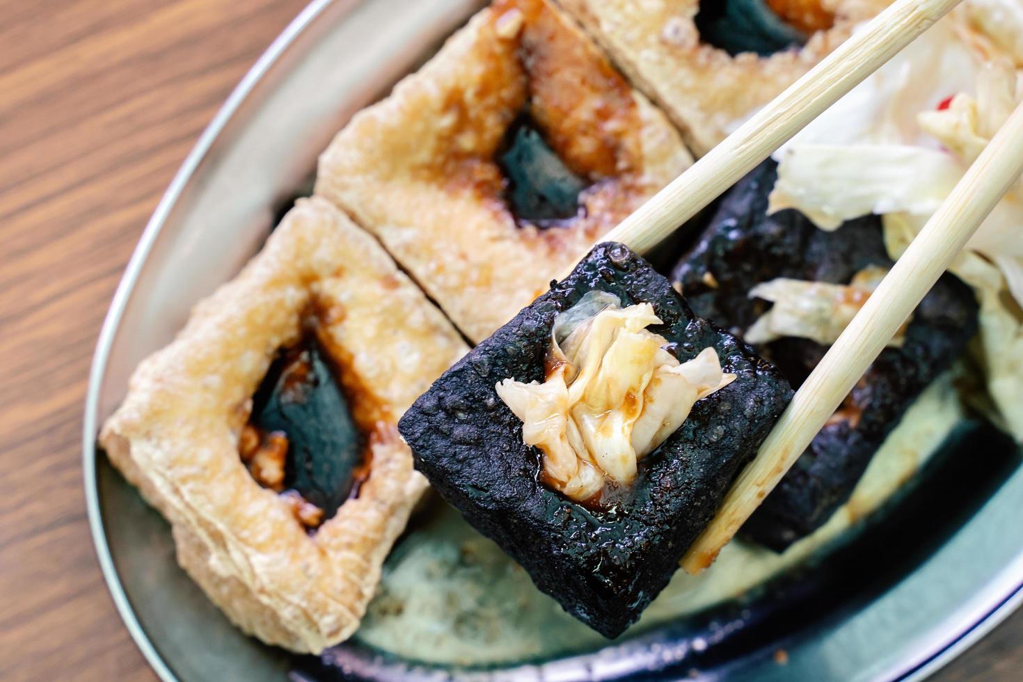 Deep fried stinky tofu with pickled cabbage, famous and delicious street food in Taiwan. photo