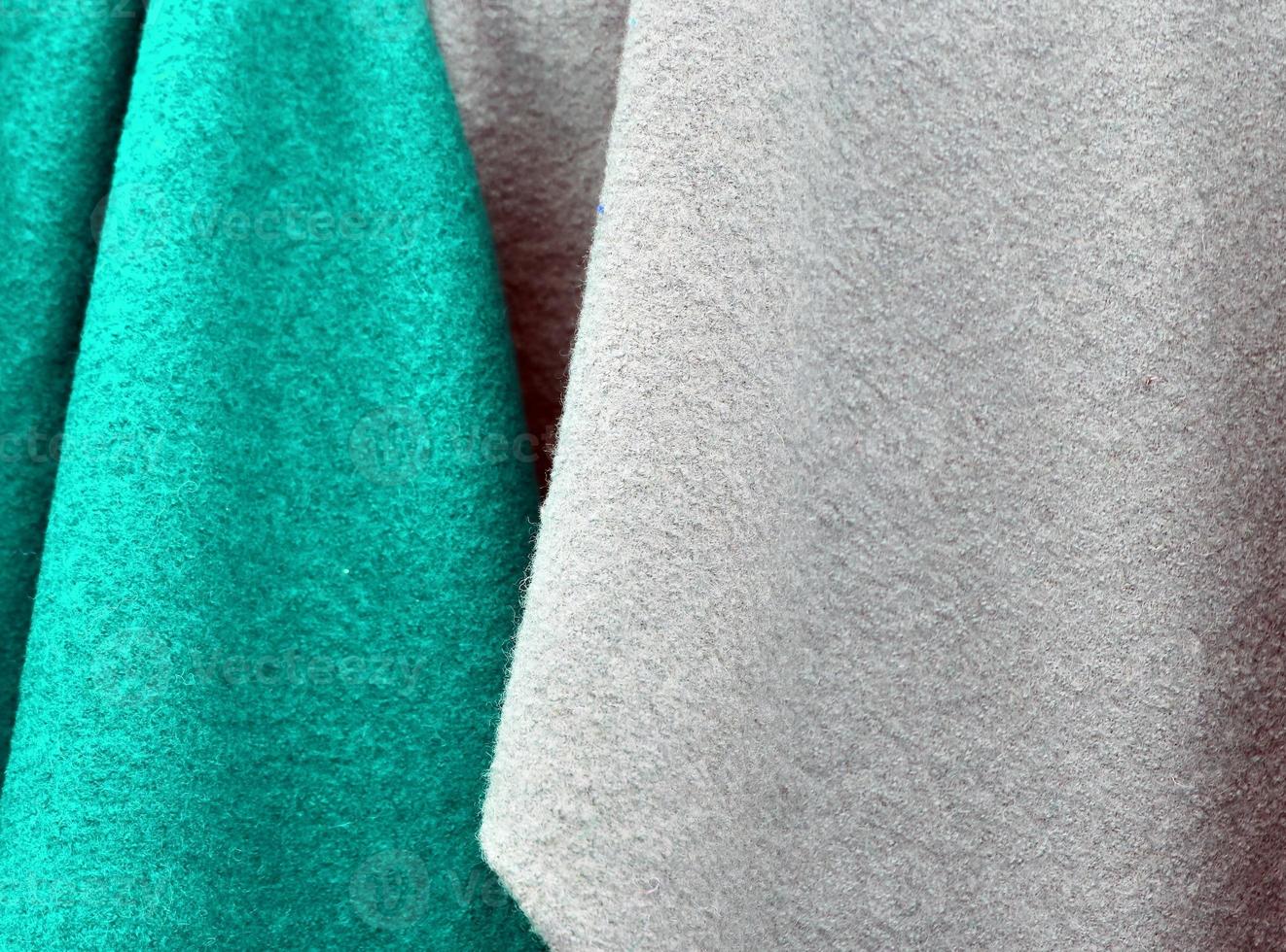 Detailed close up view on samples of cloth and fabrics in different colors found at a fabrics market photo