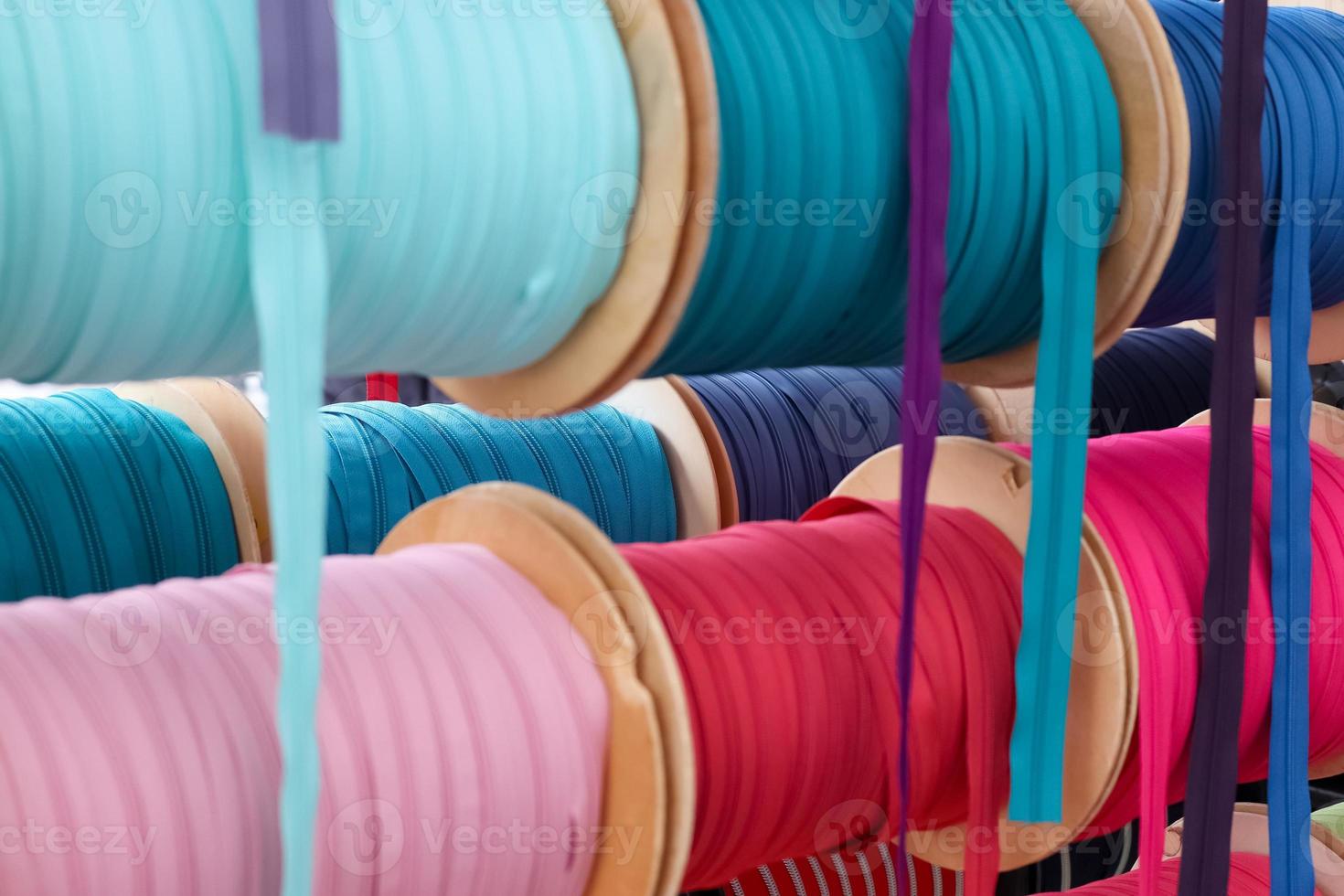 Detailed close up view on samples of cloth and fabrics in different colors found at a fabrics market photo