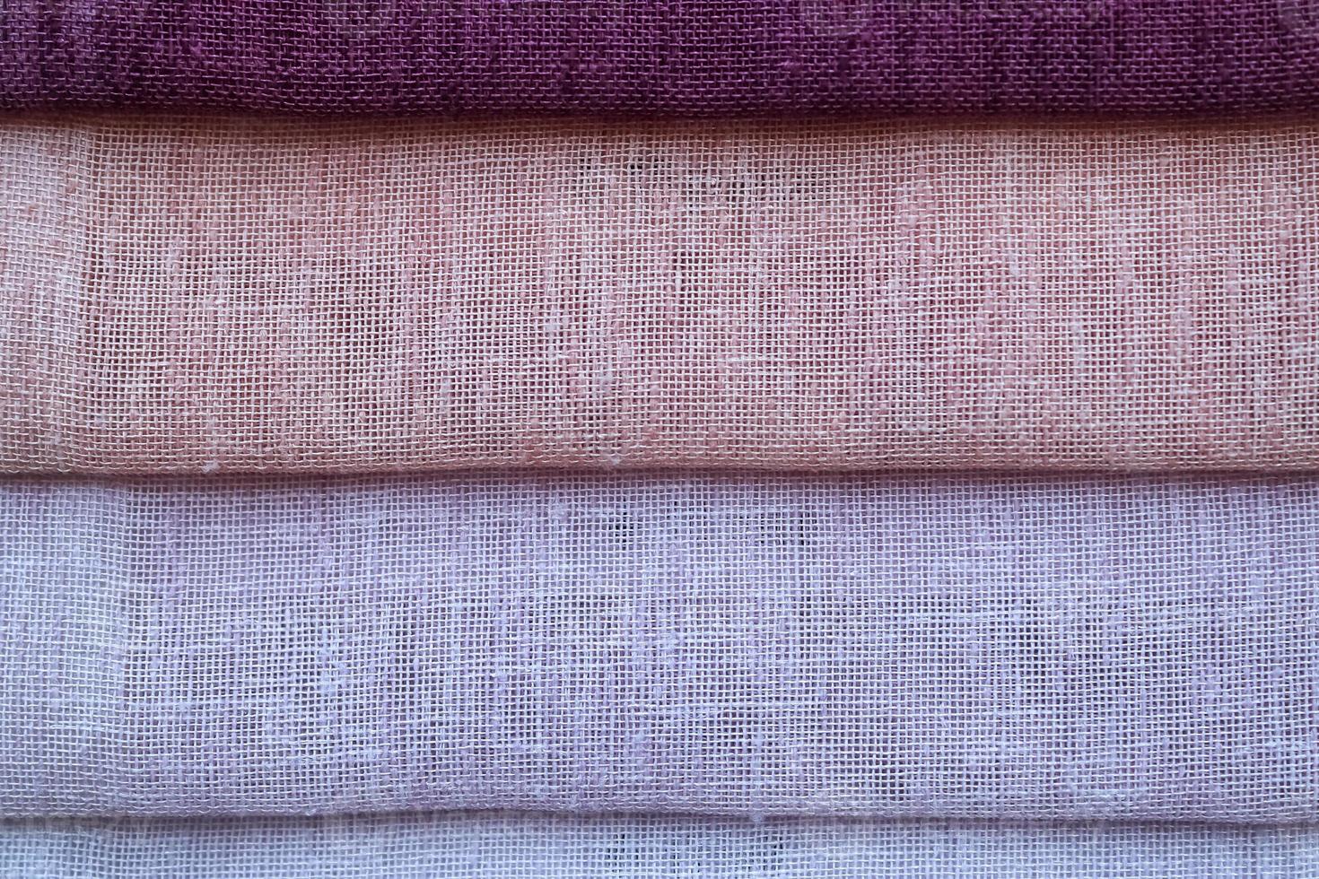 Detailed close up view on samples of cloth and fabrics in different colors found at a fabrics market photo