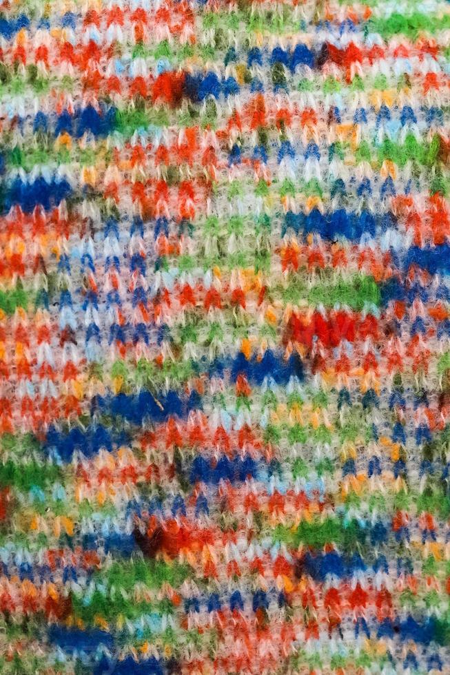 Detailed close up view on samples of cloth and fabrics in different colors found at a fabrics market photo