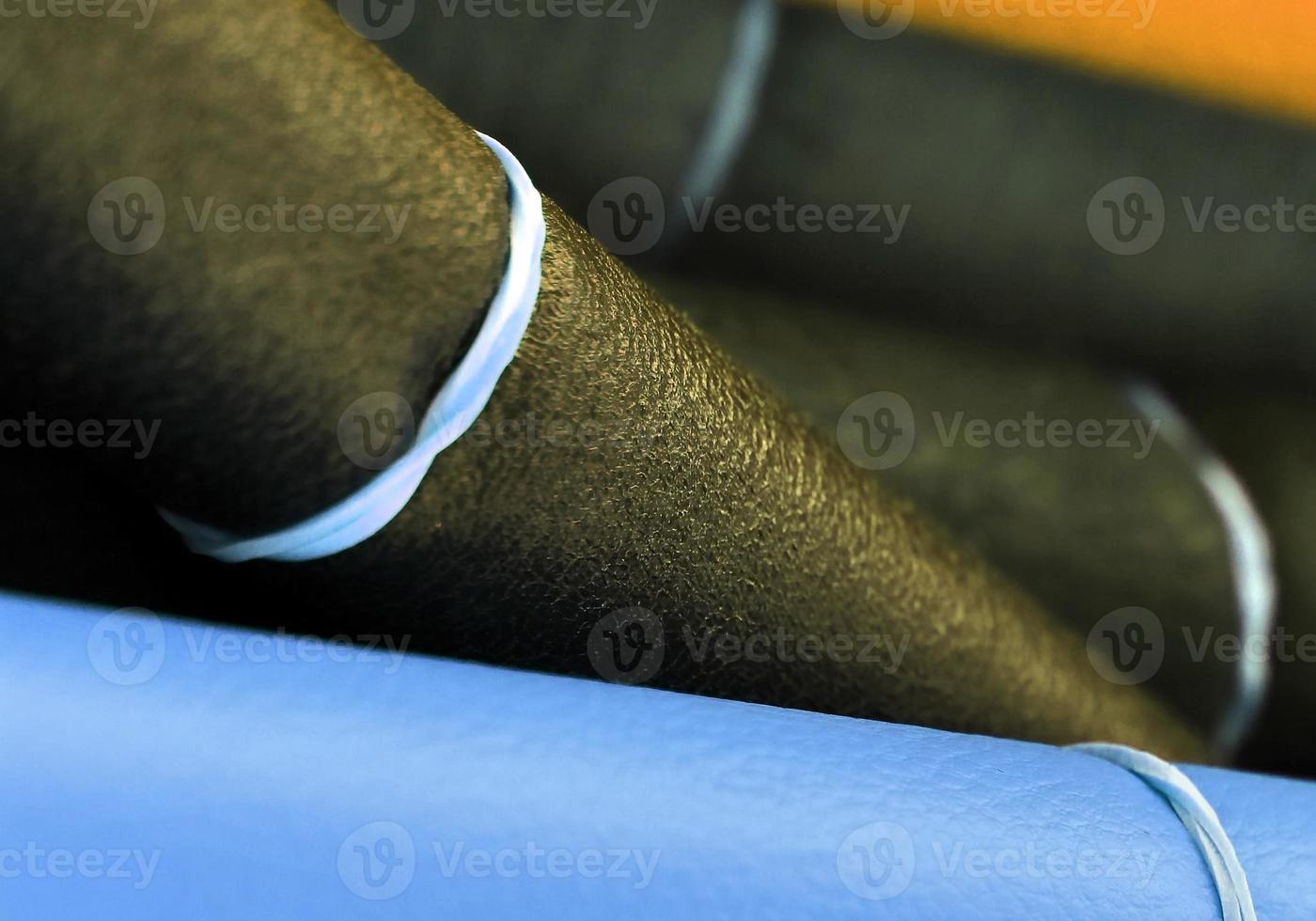 Detailed close up view on samples of cloth and fabrics in different colors found at a fabrics market photo