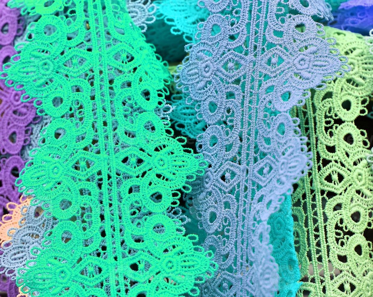 Detailed close up view on samples of cloth and fabrics in different colors found at a fabrics market photo