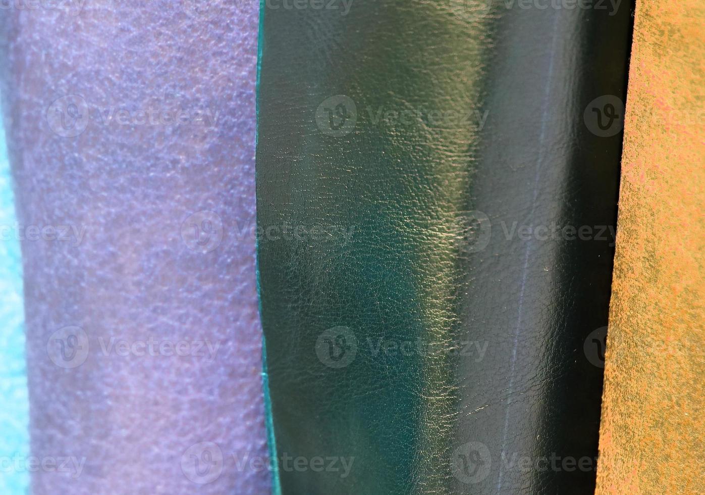 Detailed close up view on samples of cloth and fabrics in different colors found at a fabrics market photo