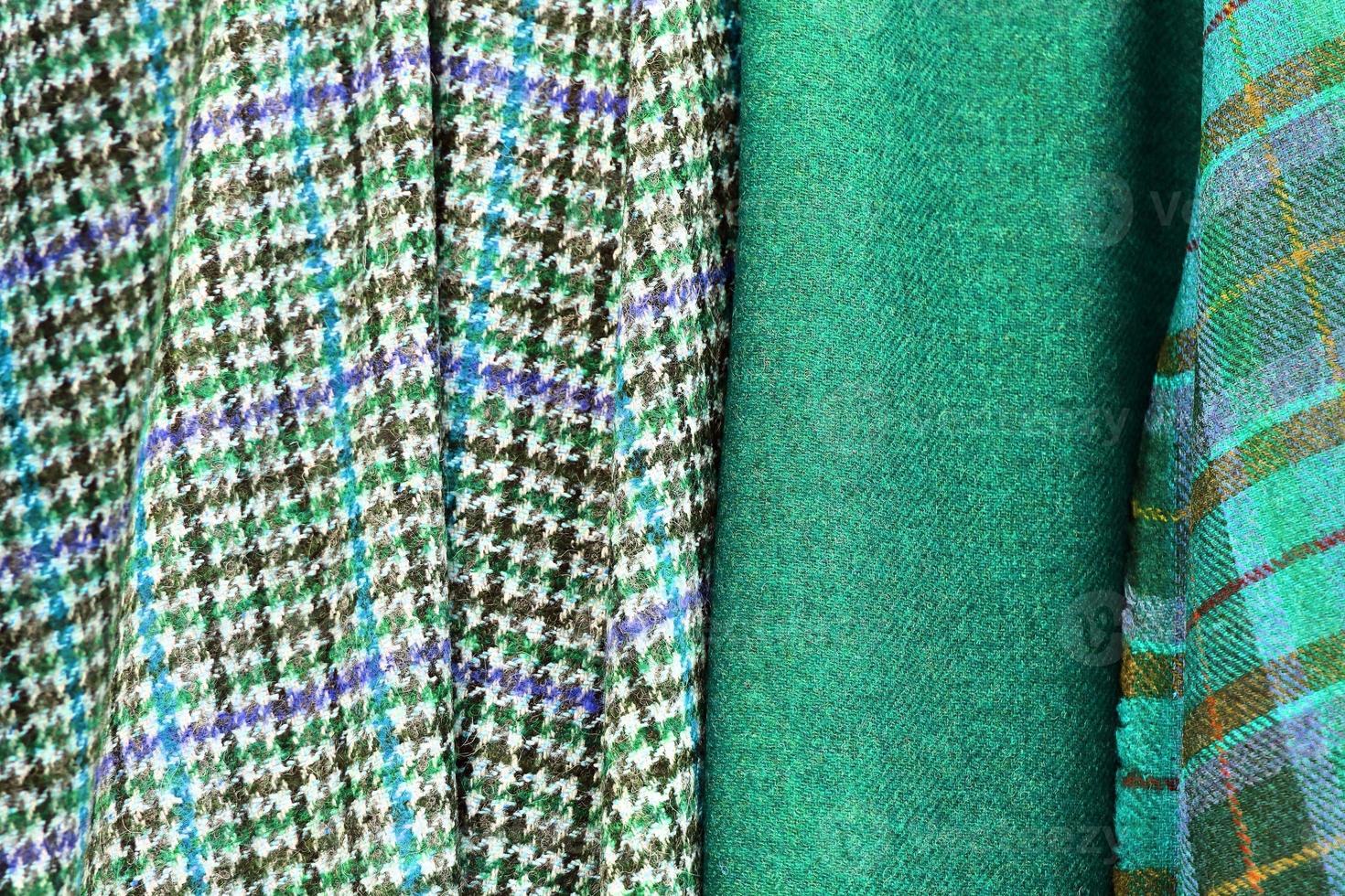Detailed close up view on samples of cloth and fabrics in different colors found at a fabrics market photo