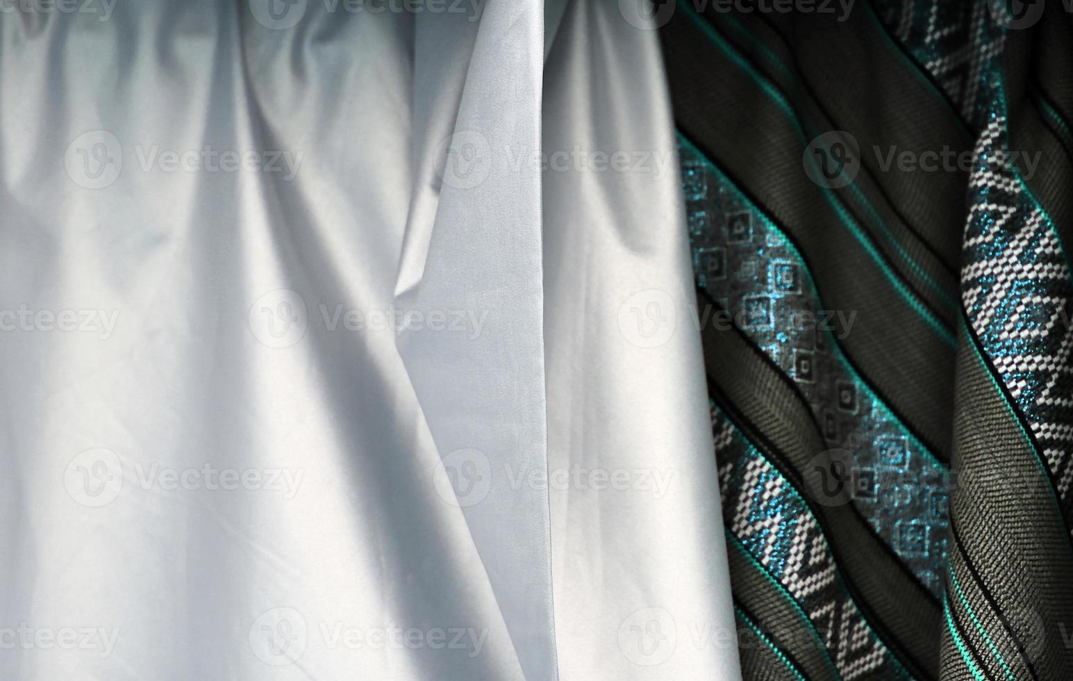 Detailed close up view on samples of cloth and fabrics in different colors found at a fabrics market photo