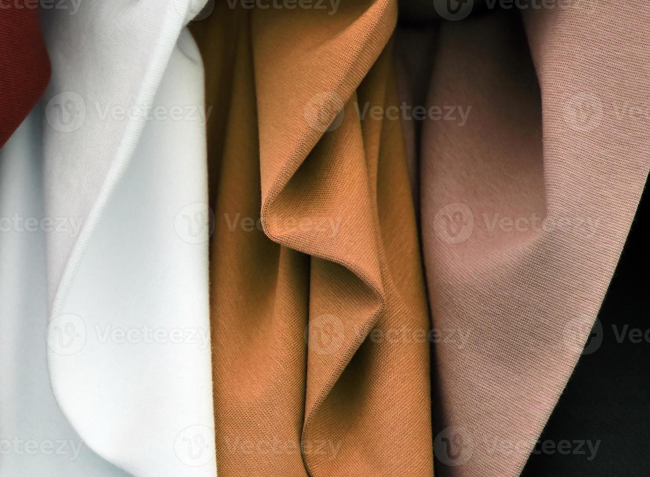Detailed close up view on samples of cloth and fabrics in different colors found at a fabrics market photo