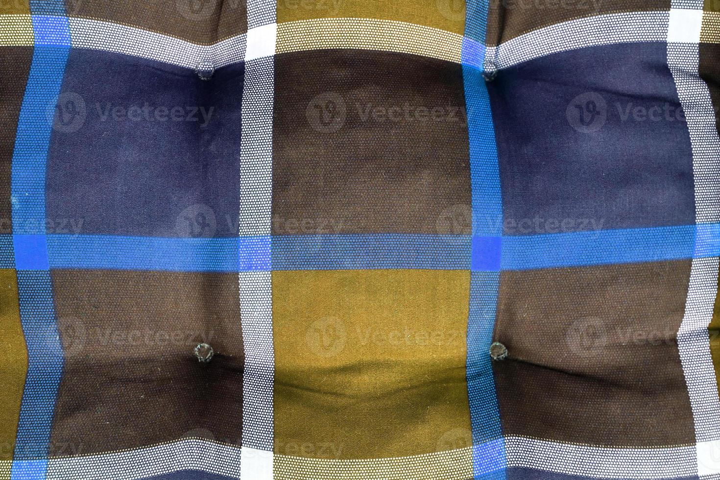 Detailed close up view on samples of cloth and fabrics in different colors found at a fabrics market photo