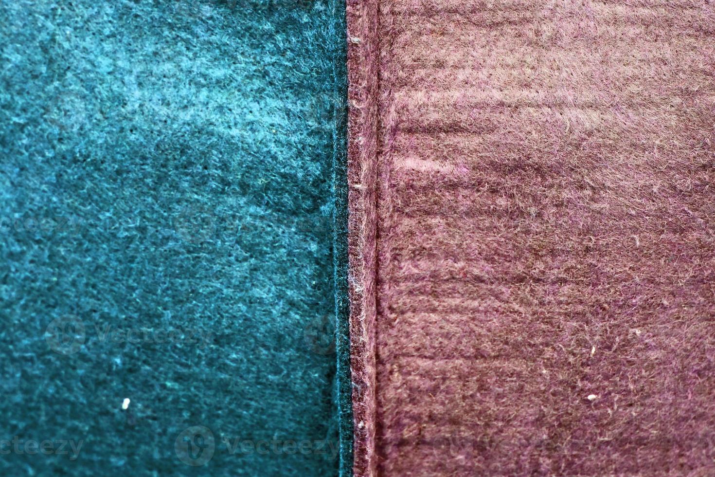 Detailed close up view on samples of cloth and fabrics in different colors found at a fabrics market photo