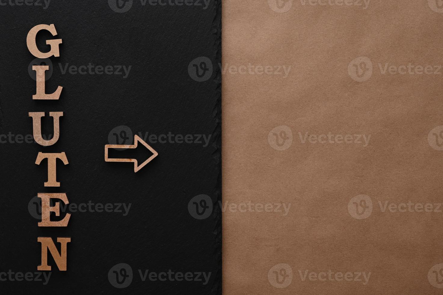 Gluten.Text in block letters on a paper background. Free space for design. photo