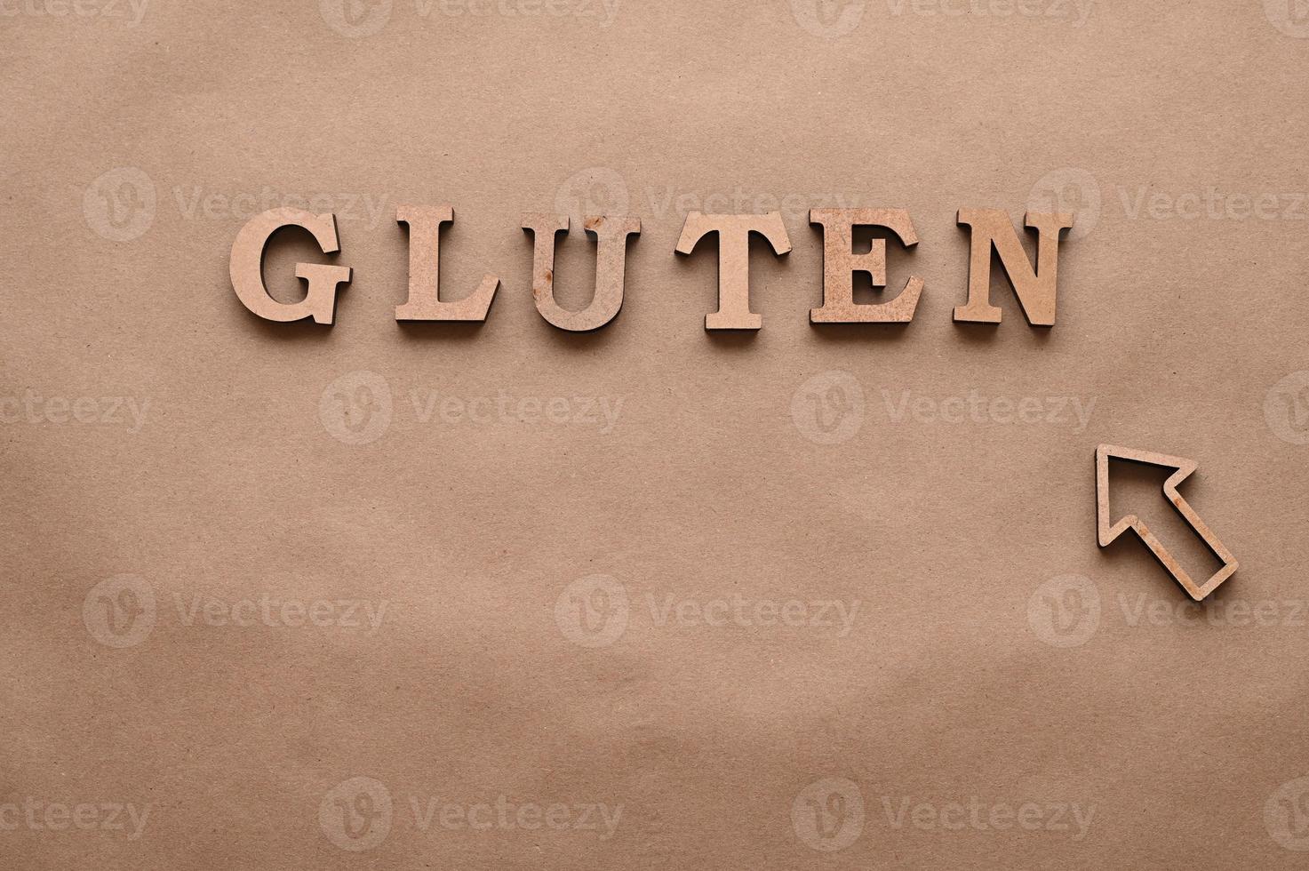 Gluten.Text in block letters on a paper background. Free space for design. photo