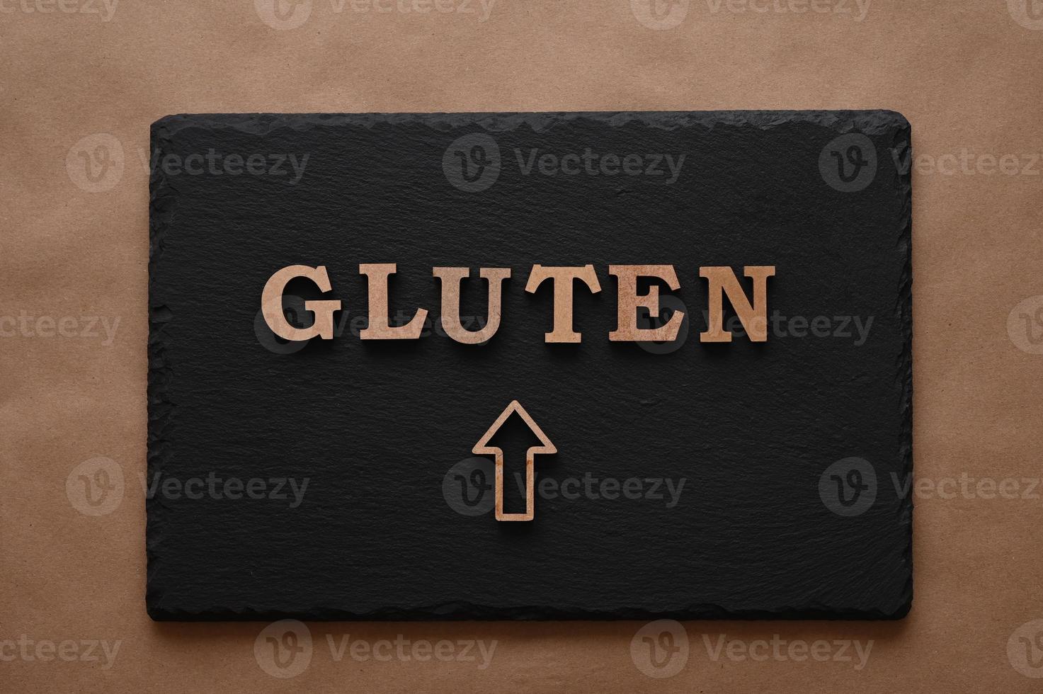 Gluten.Text in block letters on a paper background. Free space for design. photo