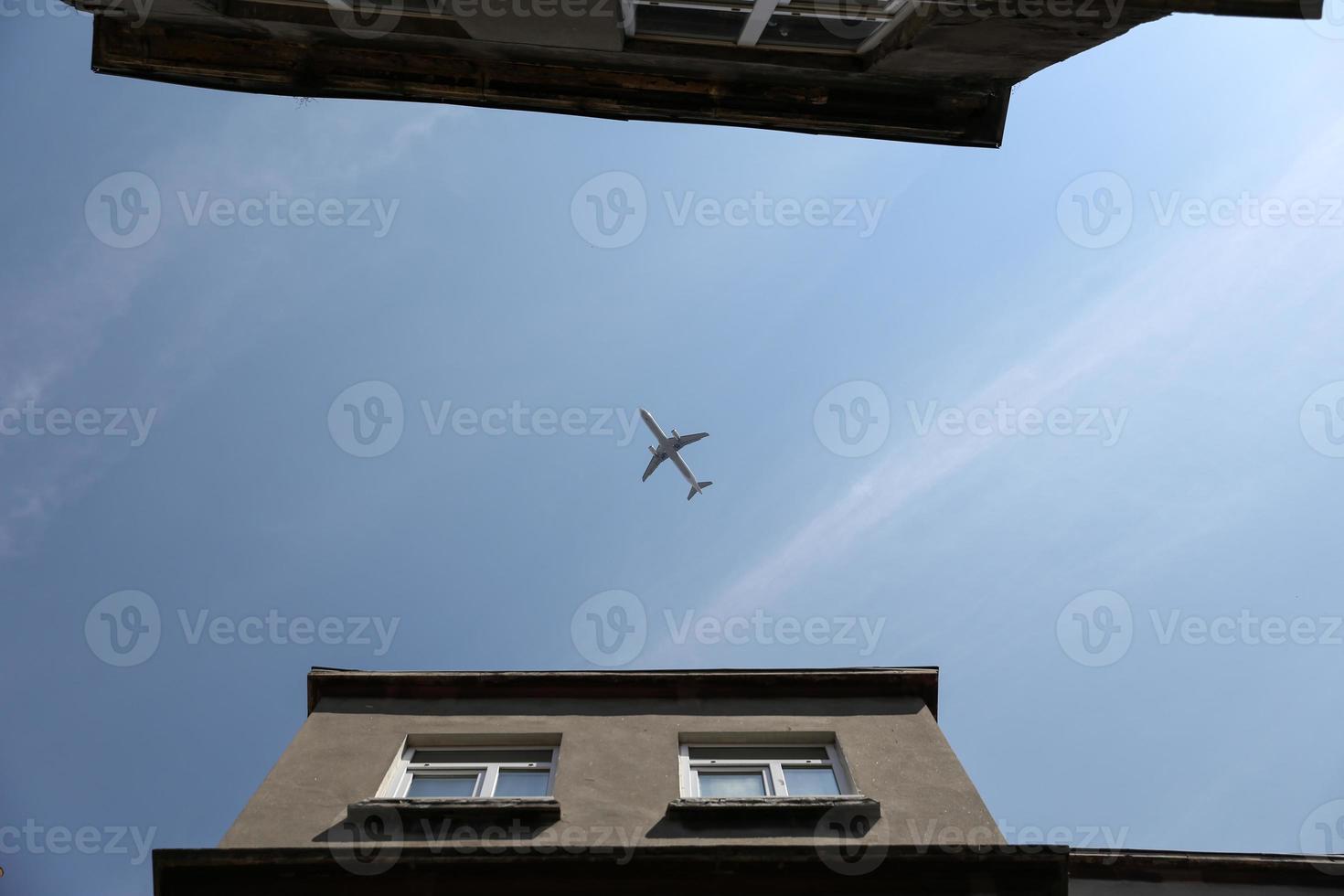 Airplane Passing Over City photo