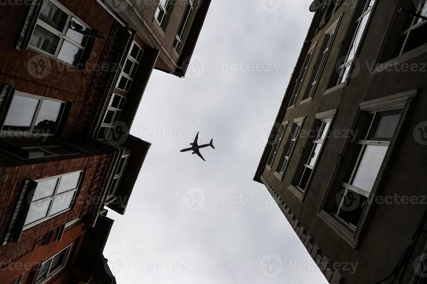 Airplane passing over Fener District in Istanbul, Turkey photo