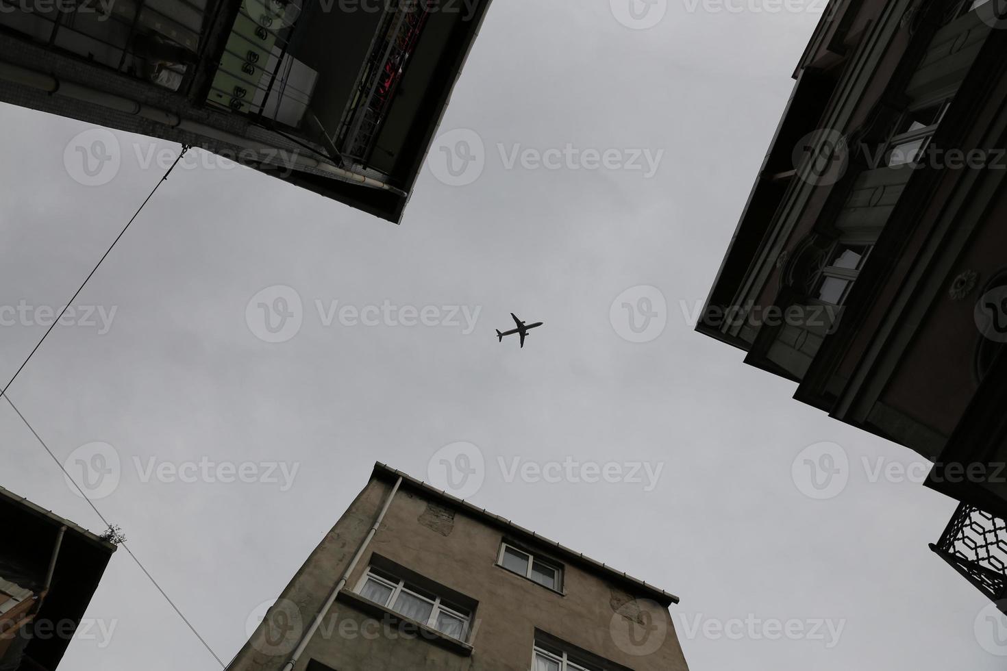 Airplane passing over Fener District in Istanbul, Turkey photo