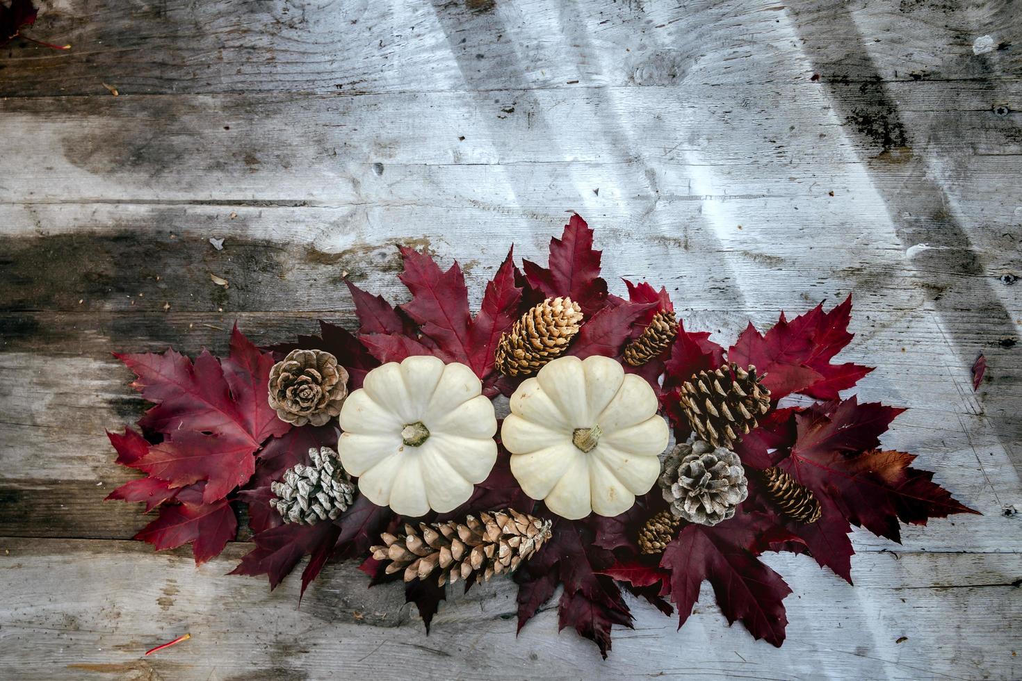 Festive autumn decor from pumpkins, pine and leaves on a  wooden background. Concept of Thanksgiving day or Halloween. Flat lay autumn composition with copy space. photo