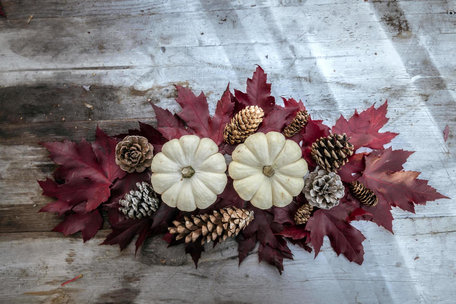 Festive autumn decor from pumpkins, pine and leaves on a  wooden background. Concept of Thanksgiving day or Halloween. Flat lay autumn composition with copy space. photo