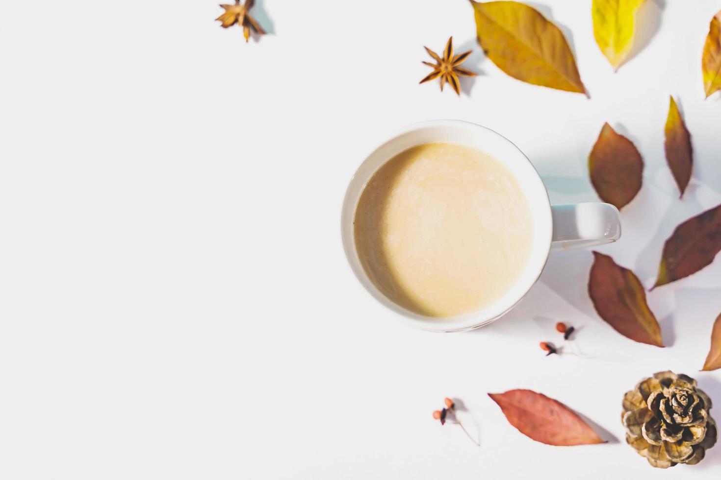 Autumn composition. Cup of coffee, autumn leaves , cinnamon sticks and anise stars on Bright Blue pastel  background. Flat lay, top view copy space. photo